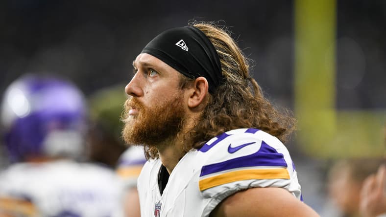 T.J. Hockenson looks on from the Vikings sideline against the Lions. vikings predictions