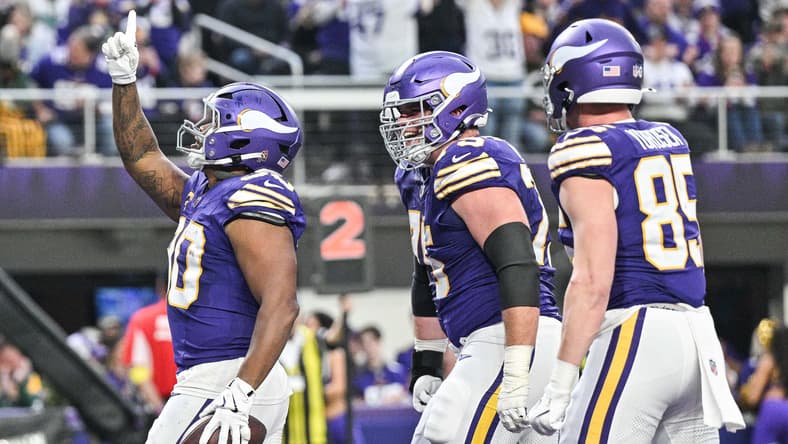 C.J. Ham, Brian O'Neill, and Ben Yurosek celebrate a Vikings touchdown during a game against the Packers at U.S. Bank Stadium.