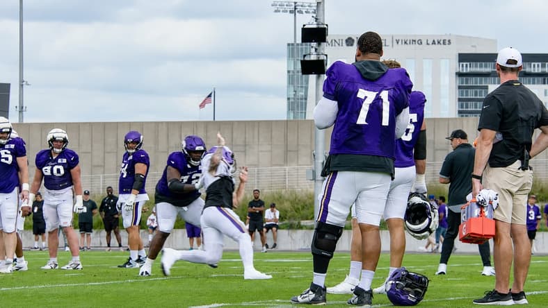 Christian Darrisaw stands near the sideline during Vikings training camp.