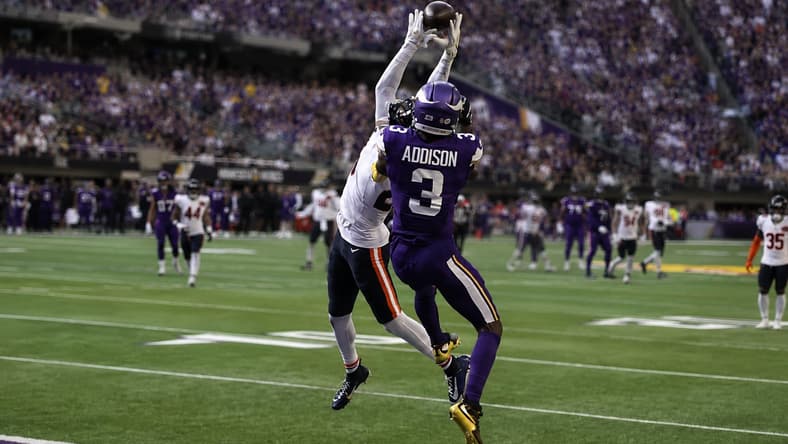 Jordan Addison battles Nahshon Wright for a contested catch against the Bears.
