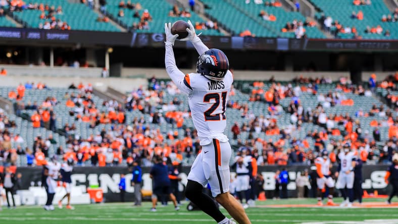 Riley Moss catches a football during Broncos warmups before facing the Bengals.