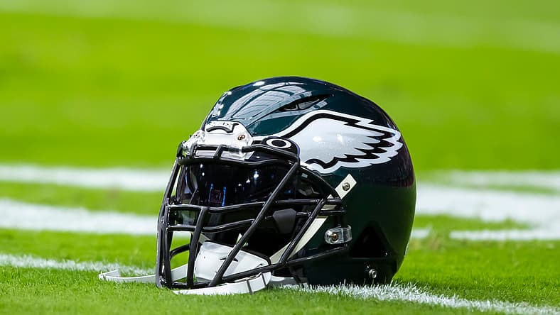 Close-up view of a Philadelphia Eagles helmet on the sideline at State Farm Stadium in Glendale.