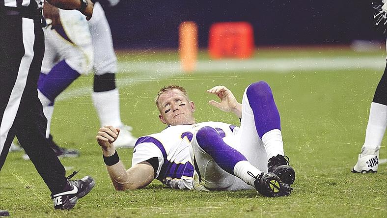 Vikings player lying on field during game after apparent injury or tackle.