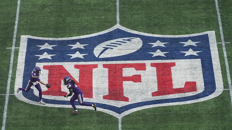 Kirk Cousins hands off to Dalvin Cook on the midfield NFL shield during the Vikings’ International Series game in London.