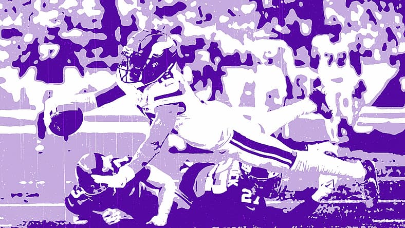 Minnesota Vikings player diving for the football during game action.