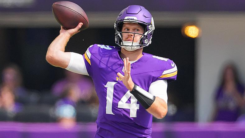 Vikings quarterback number 14 throwing football during game.
