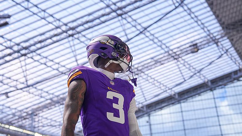 Jordan Addison stretches during pregame warmups before a Vikings preseason game against the Raiders at U.S. Bank Stadium.