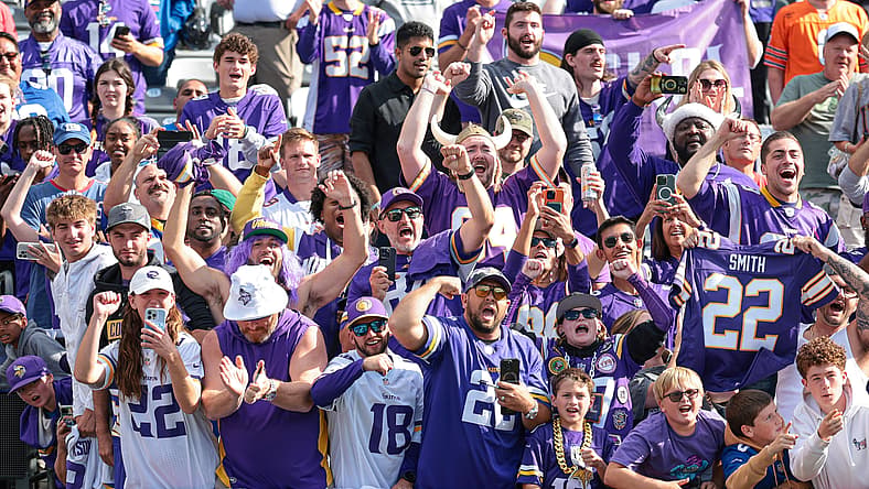 Vikings fans celebrate along the lower bowl railing at MetLife Stadium following a road win in East Rutherford.