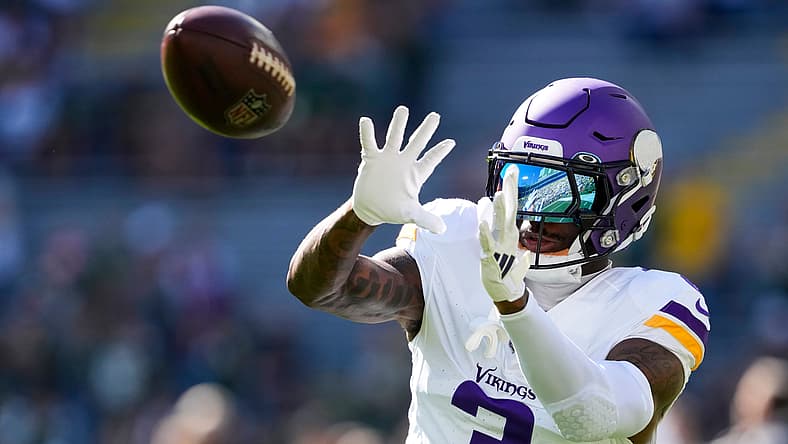 Vikings wide receiver Jordan Addison catches a pass during pregame warmups at Lambeau Field.