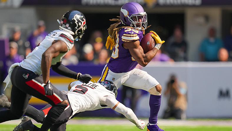 Aaron Jones carries the football against the Houston Texans at U.S. Bank Stadium.