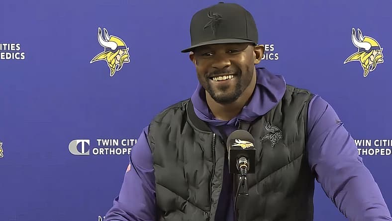 Brian Flores speaks with reporters at the TCO Performance Center during the 2024 Vikings season.