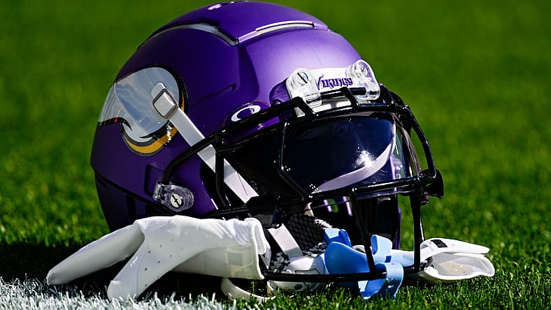 A Minnesota Vikings helmet sits on the field before a game at Lambeau Field.