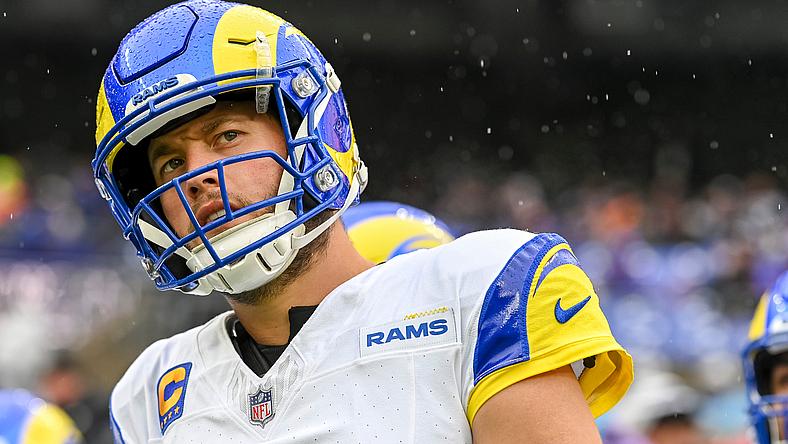 LA Rams player in blue and yellow helmet during NFL game.