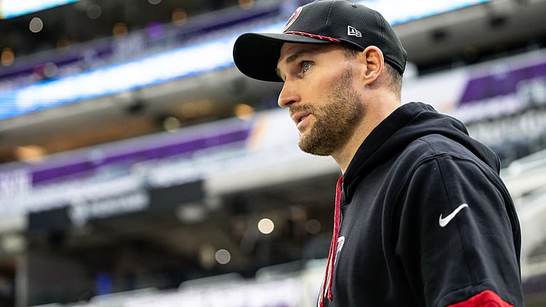 Kirk Cousins walks onto the field before facing his former team, the Minnesota Vikings, at U.S. Bank Stadium.