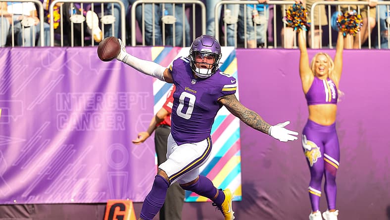 Ivan Pace Jr. celebrates after returning a fumble for a touchdown during a Vikings game against the Detroit Lions.