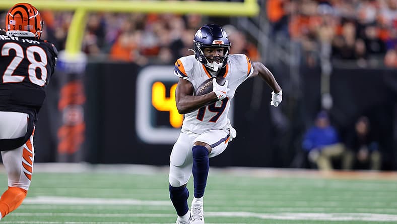 Jaleel McLaughlin runs for a first down against the Bengals.