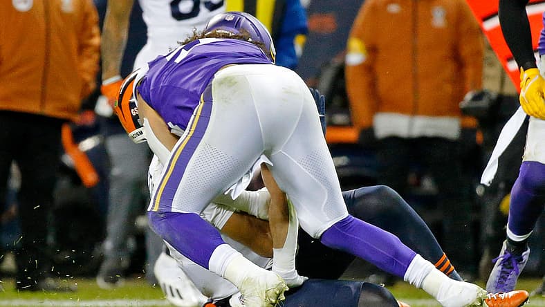 Justin Fields brought down by a Vikings defender in 2021.