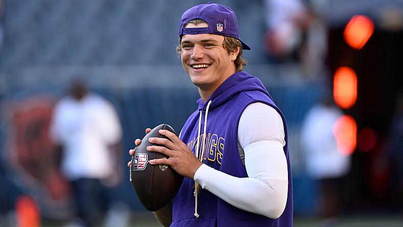 J.J. McCarthy warms up on the field before a Vikings game against the Bears at Soldier Field.