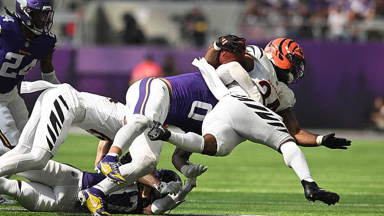 Ivan Pace Jr. tackles Samaje Perine during a Vikings game.