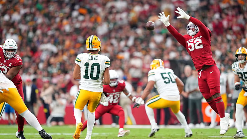 Jordan Love throws a pass over Jordan Burch against the Cardinals. Jordan Love NFL Top 100 ranking