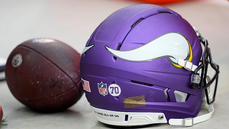 Minnesota Vikings helmet resting on the field before a game at Lambeau Field.