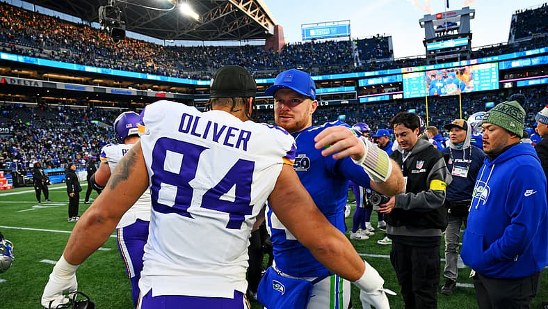 Seahawks QB Sam Darnold and TE Josh Oliver embrace in 2025