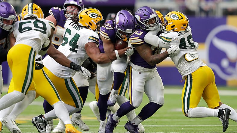 Jordan Mason runs with the football during the Vikings game against the Green Bay Packers at U.S. Bank Stadium.