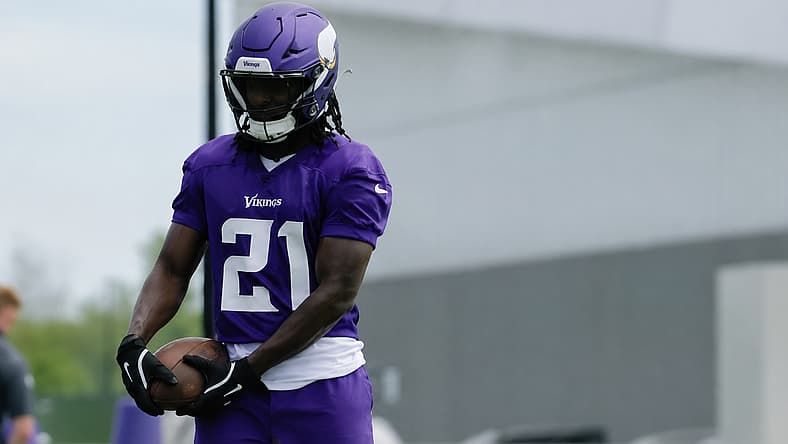 Demond Claiborne holds a football during Vikings OTAs in Eagan.