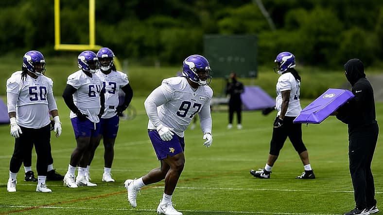 Domonique Orange attacks a blocking pad during Vikings minicamp.