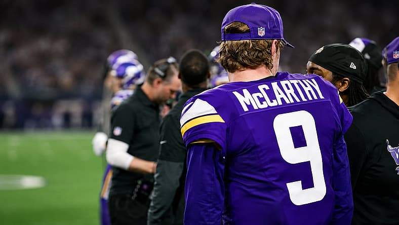 J.J. McCarthy stands on the Vikings sideline against the Cowboys.