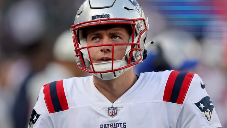 Mac Jones watches from the sideline during the Patriots–Jets game. Jones could a Vikings QB option in 2026.