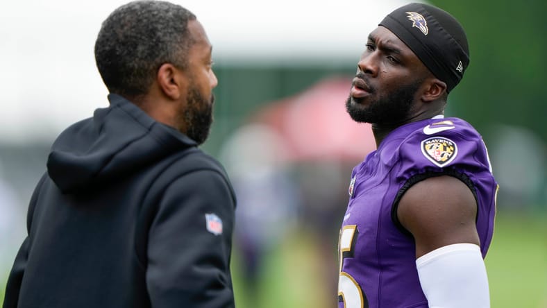 Nelson Agholor talks with WR coach at camp.