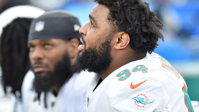 Christian Wilkins speaks with a coach on the sideline during a Dolphins game at Gillette Stadium. The VIkings wanted Wilkins in 2024.