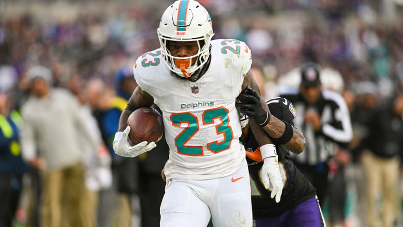 Jeff Wilson Jr. runs the ball for the Dolphins against the Ravens.