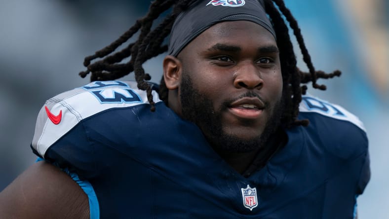 T'Vondre Sweat runs onto the field before a Titans home game.