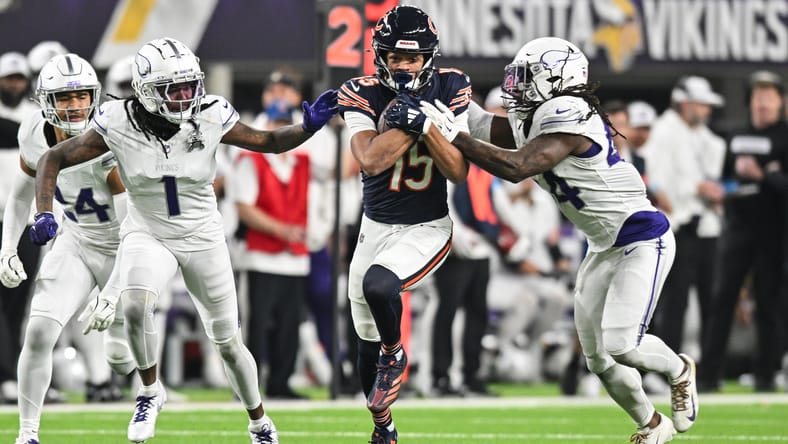 Rome Odunze runs after catch vs. Vikings defenders at U.S. Bank Stadium.