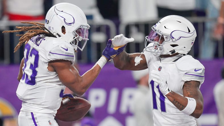 Minnesota Vikings running back Aaron Jones celebrates a touchdown with teammate Trent Sherfield during a 2024 game against the Bears.