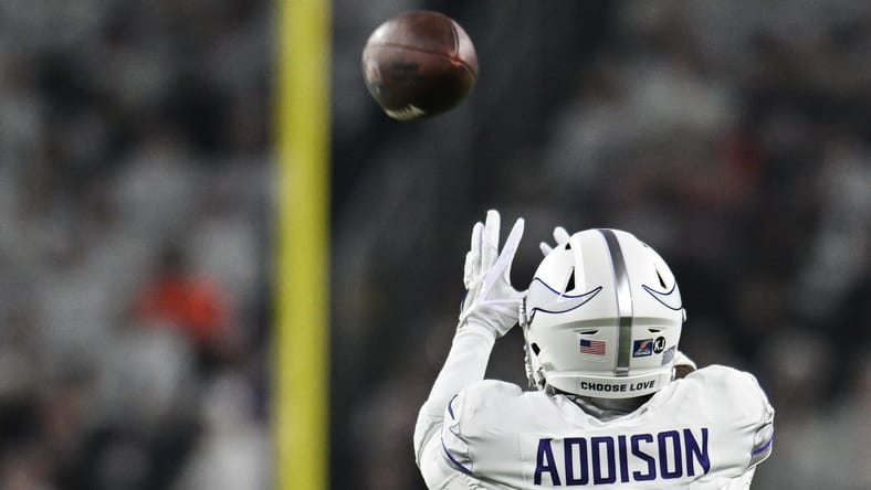 Jordan Addison reaches for a pass in 2024 agains the Chicago Bears.