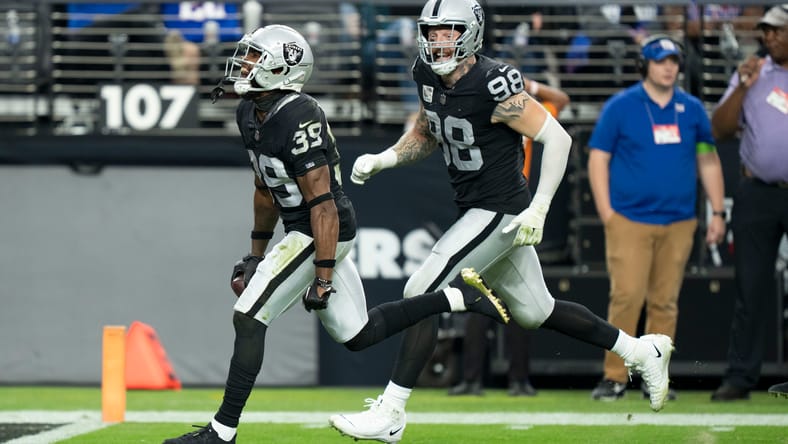 Nate Hobbs and Maxx Crosby celebrate after Hobbs' interception versus the New York Giants.