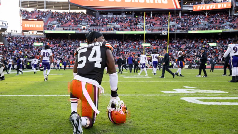 Cleveland Browns defensive end Ogbo Okoronkwo (54) kneels after a win over the Ravens on Oct. 27, 2024.
