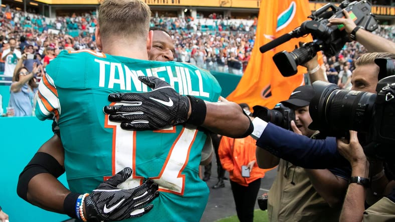 Ryan Tannehill embraces Kenyan Drake after Miami's miraculous game-winning play versus New England.