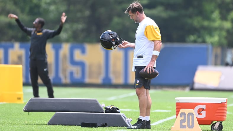 Pittsburgh Steelers quarterback Aaron Rodgers looks over his helmet during minicamp.