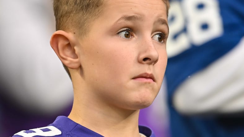 A young Vikings fans looks on during a 2022 regular season game.