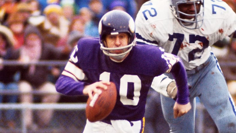 Fran Tarkenton scrambles under pressure from Ed “Too Tall” Jones in the 1975 playoffs.
