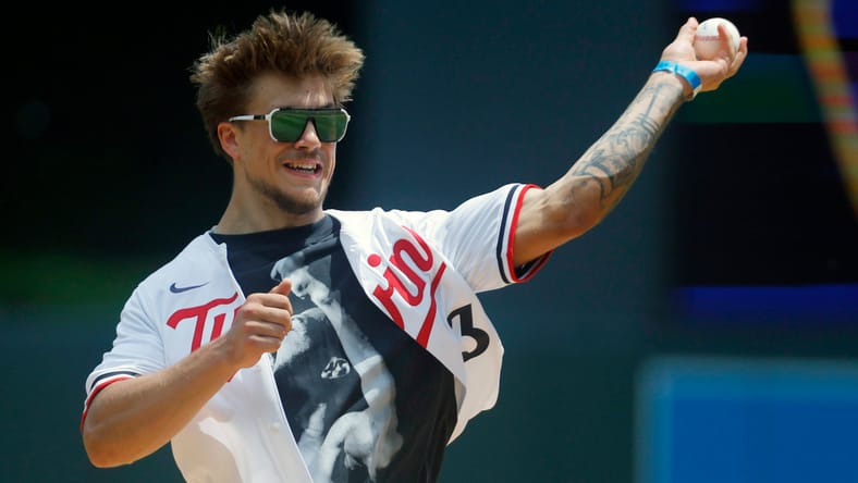 Koi Perich, a Golden Gopher, throws out a pitch a Twins game
