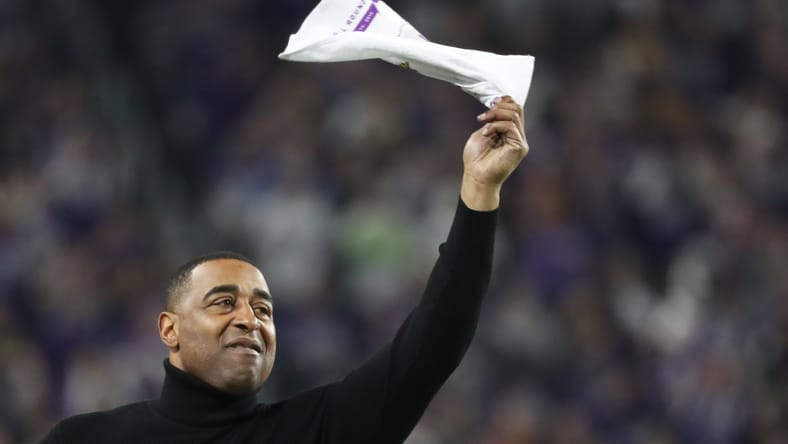 Cris Carter waves a rally towel during a Vikings playoff game in 2018.