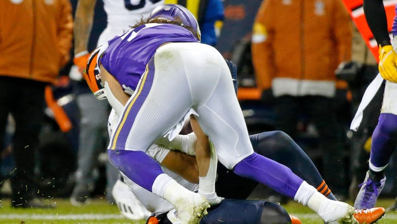 Justin Fields brought down by a Vikings defender in 2021.
