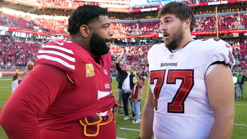 Trent Williams and Justin Skule chatting in 2023.