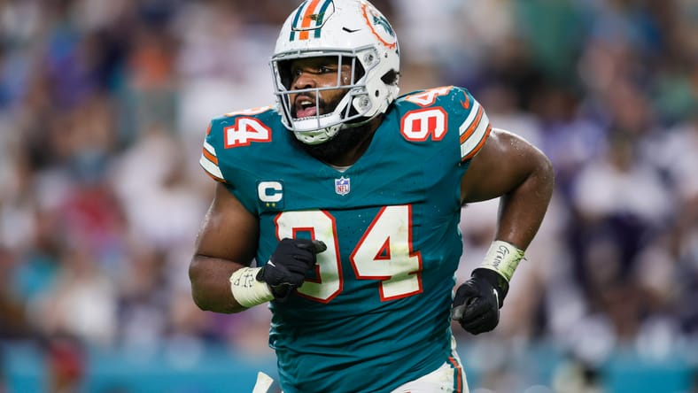 Christian Wilkins watches from the field during a 2023 Dolphins game vs. Cowboys.