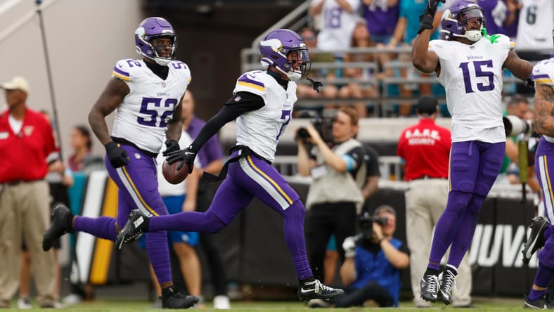 Vikings defenders celebrate late INT vs. Jaguars in November 2024